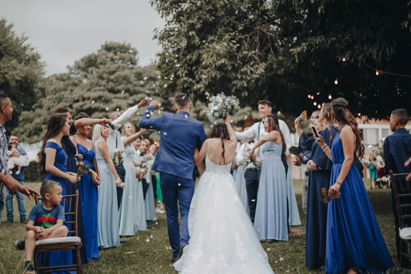 Guests dancing on the grass at an outdoor reception