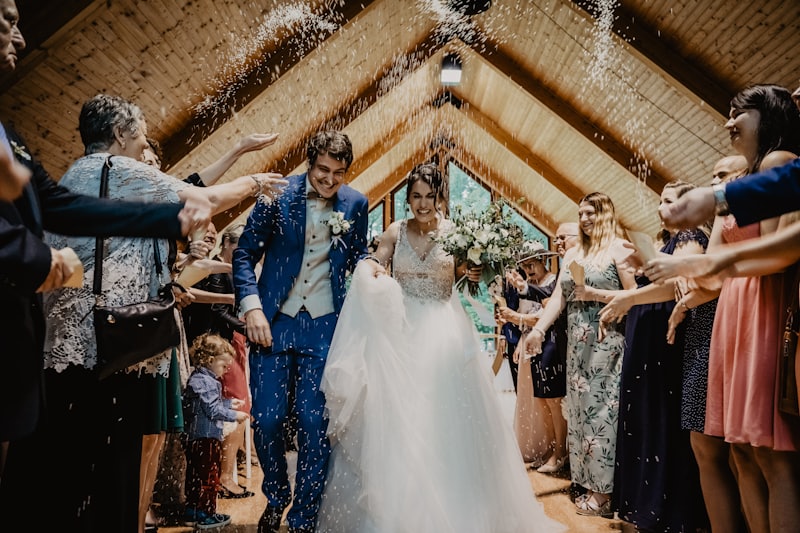 A bride and groom against a timber wall