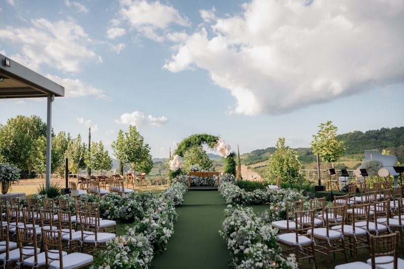 An outdoor ceremony set up with chairs and flowers